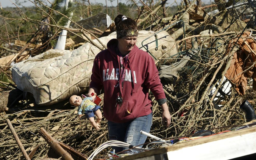 A resident of Beauregard, Alabama, searches for belongings on Wednesday, March 6.