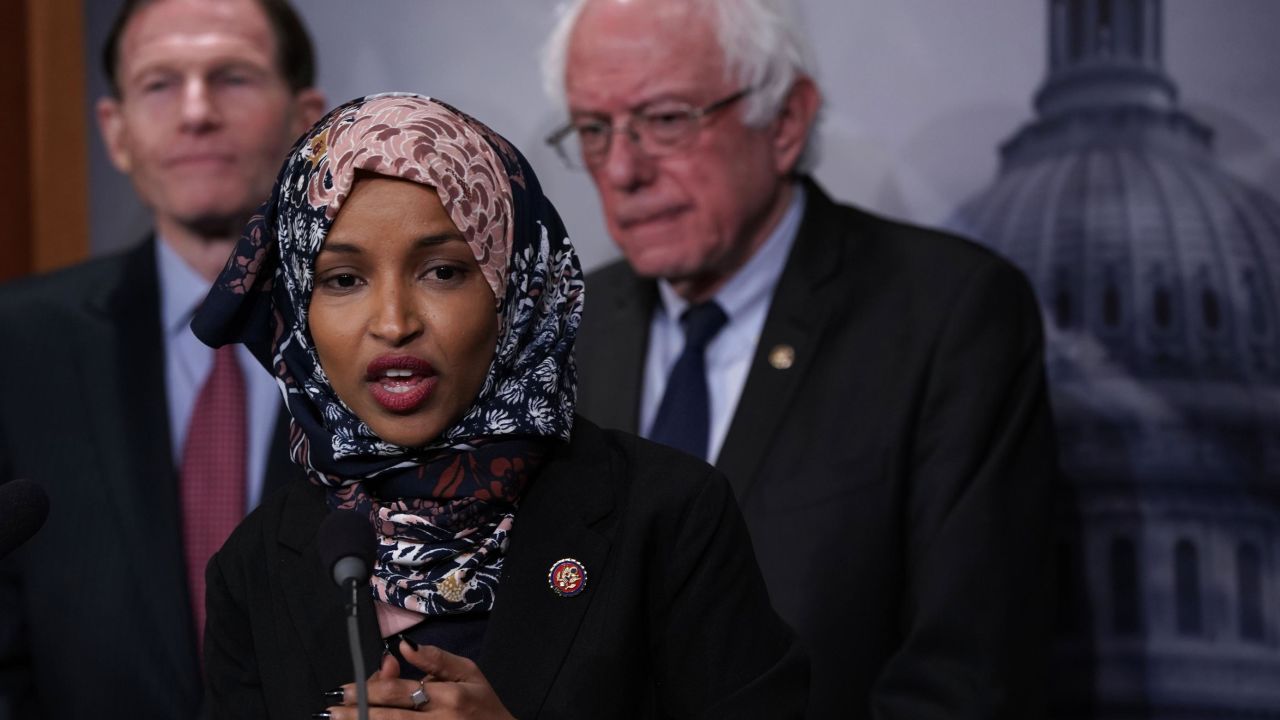 WASHINGTON, DC - JANUARY 10:   U.S. Rep. Ilhan Omar (D-MN) (2nd L) speaks as Sen. Richard Blumenthal (D-CT) (L) and Sen. Bernie Sanders (I-VT) (R) listen during a news conference on prescription drugs January 10, 2019 at the Capitol in Washington, DC. Congressional Democrats held a news conference to introduce a legislative package "that would drastically reduce prescription drug prices in the United States." (Photo by Alex Wong/Getty Images)