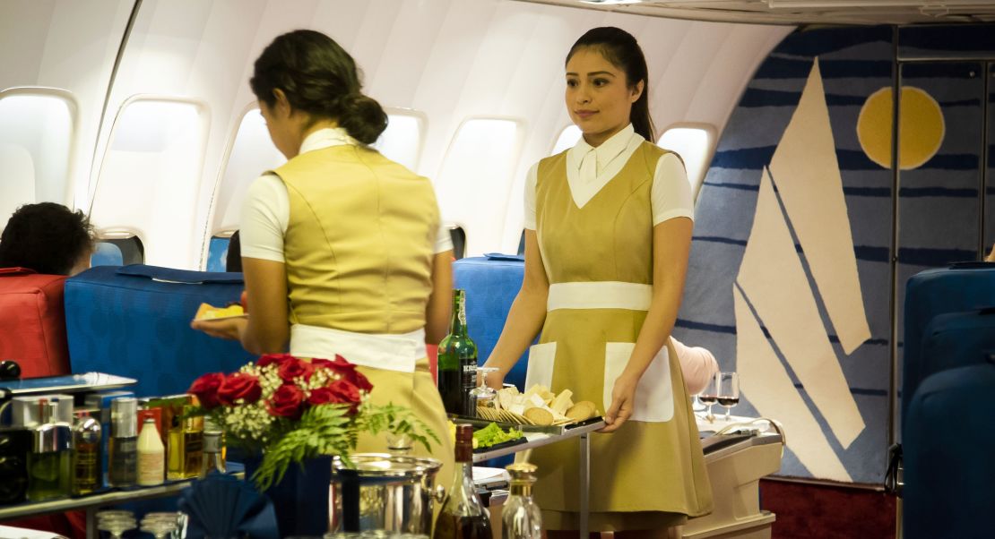 "Flight attendants" serve passengers their meals.