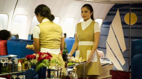 "Flight attendants" serve passengers their meals. 