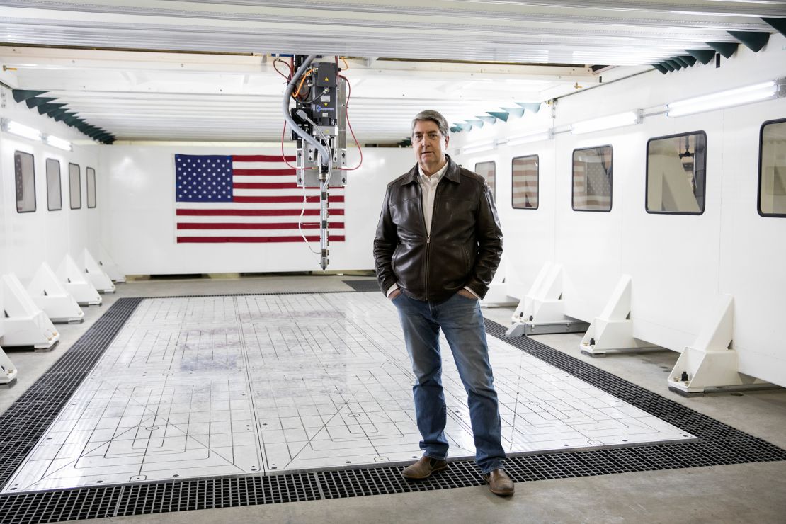 Michael Garvey, CEO of M7 Technologies, stands next to one of the biggest 3D printers in the world in Youngstown, Ohio.