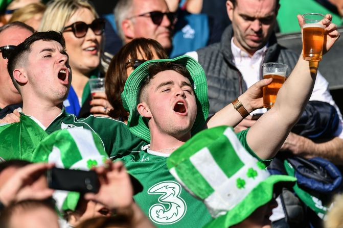 Look at those eyes fixed on that outstretched pint. The wide-brim hat is a lovely touch.