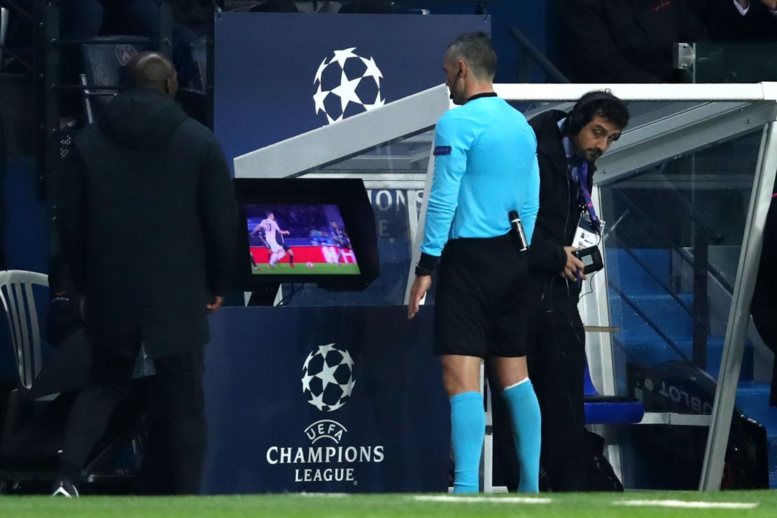 Match referee Damir Skomina checks the VAR system before awarding a penalty in favor of Manchester United.