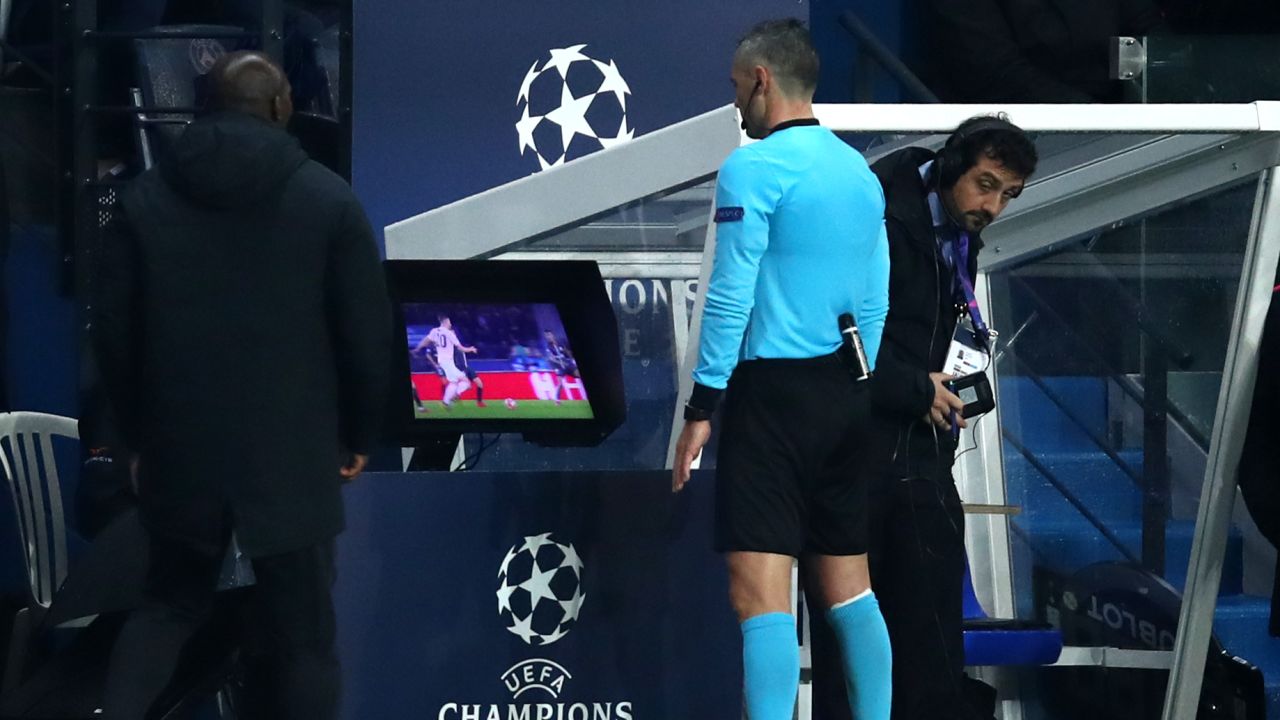 Match referee Damir Skomina checks the VAR system before awarding a penalty in favor of Manchester United.