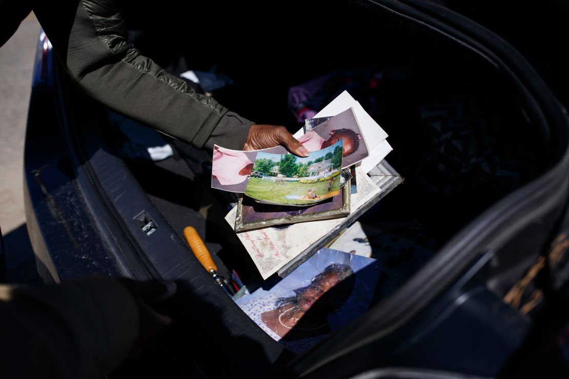 Krystal Stenson-Garrett puts away pictures of her family that neighbors and clean-up volunteers found in the wreckage, hundreds of yards from where her parent's home used to be.