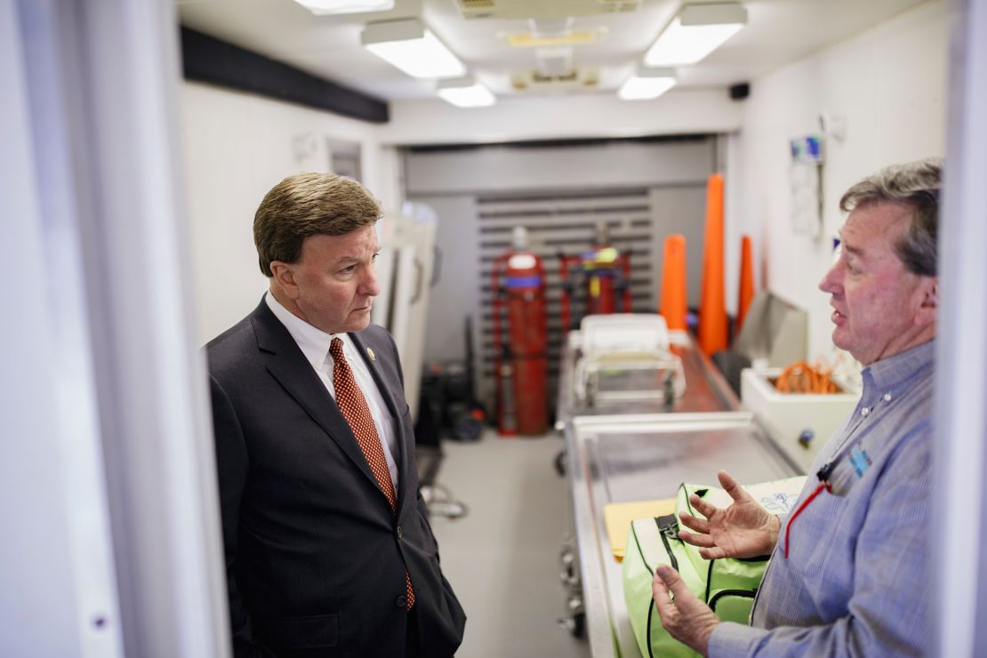 Republican Rep. Mike Rogers of Alabama, left, talks with Lee County Coroner Bill Harris in a mobile autopsy trailer in Beauregard.