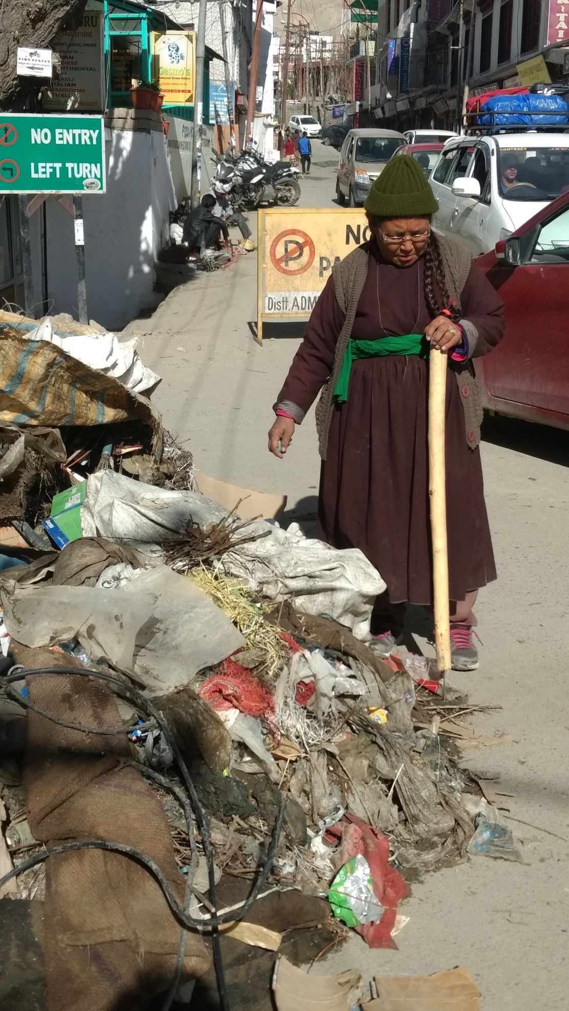 The president of the Women's Alliance of Ladakh examines a pile of plastic waste collected in Leh, northern India.