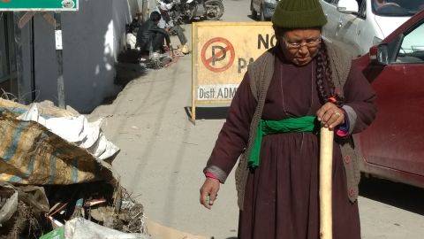 The president of the Women's Alliance of Ladakh examines a pile of plastic waste collected in Leh, northern India.