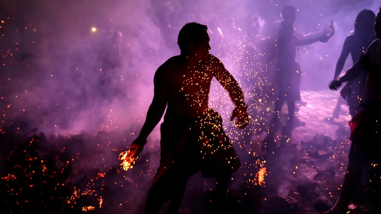 A man in Gianyar, Indonesia, holds a burning coconut shell during Mesabetan Api, a Hindu purification ritual, on Wednesday, March 6.