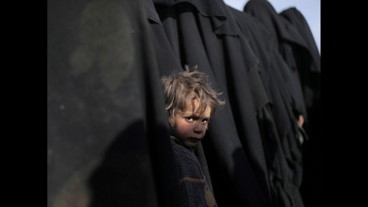 A boy looks at the camera near the Syrian town of Baghouz Al-Fawqani on Tuesday, March 5. The town is where the US-backed Syrian Democratic Forces <a href="https://www.cnn.com/2019/03/05/middleeast/syria-baghouz-isis-fighters-surrender-intl/index.html" target="_blank">recently launched an offensive</a> to oust ISIS from its last enclave in Syria.