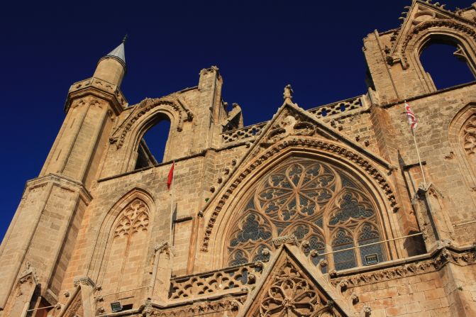 <strong>Famagusta Mosque.</strong> Flags of Turkey and the Turkish Republic of Northern Cyprus fly from the Gothic facade of Lala Mustafa Pasha Mosque, which was built as a cathedral in the 14th century, then turned into a mosque under Ottoman rule.