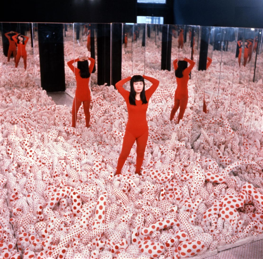 Kusama pictured inside her work "Infinity Mirror Room -- Phalli's Field" in 1965. The floor of the installation was covered with stuffed polka-dot phalluses.