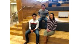 Nick Paraiso and Thomas Krasnican, co-hosts of the "Thank You For Your Service" podcast, with Sarah Claudy, who acts as creative consultant for show, in the lobby of the University of Chicago Harris School of Public Policy.