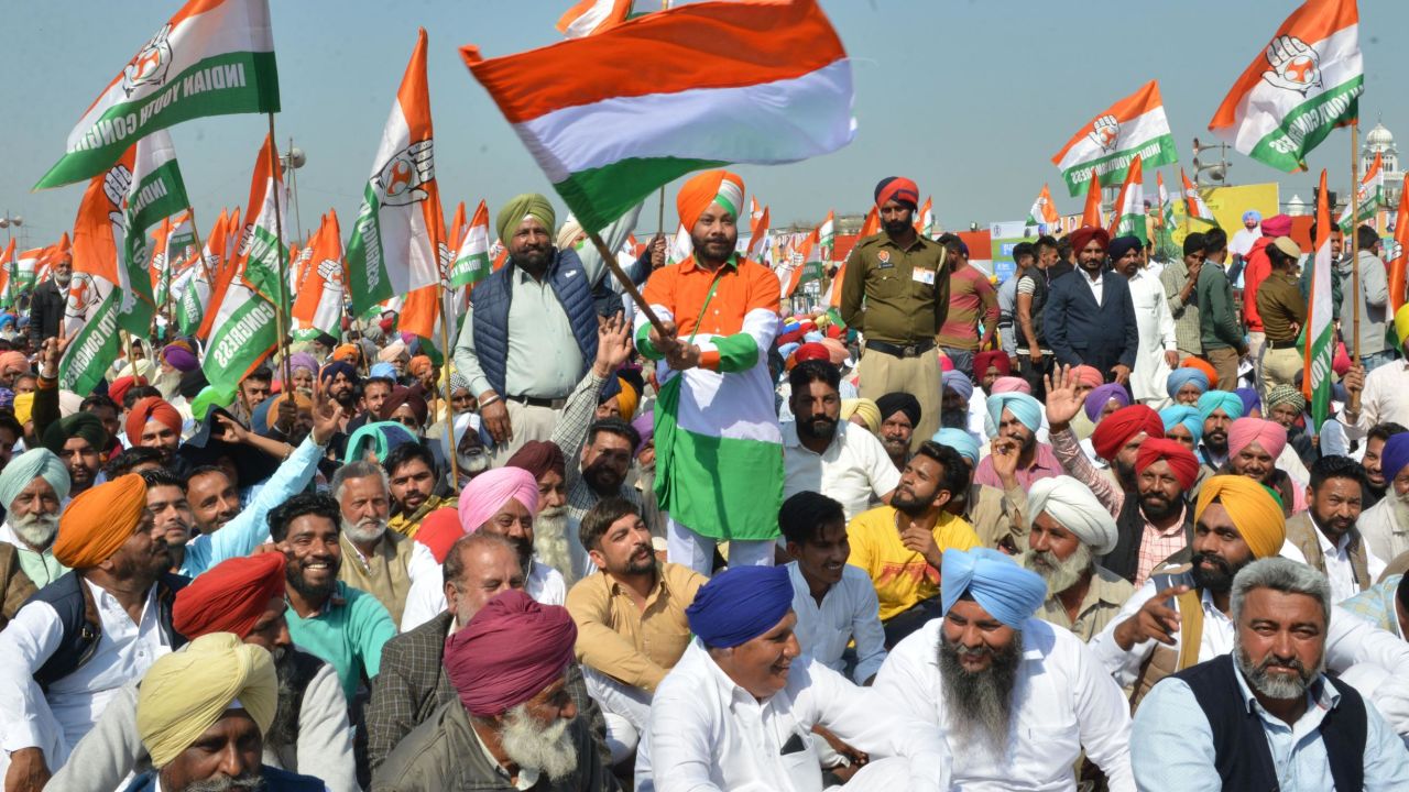 Congress party supporters hold party flags during the launch of the party's campaign in Punjab ahead of the upcoming elections.