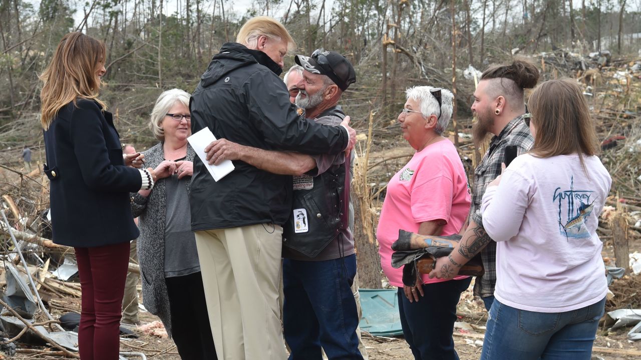 President Donald Trump meets residents Friday in Beauregard, Alabama, as he tours tornado-hit areas.