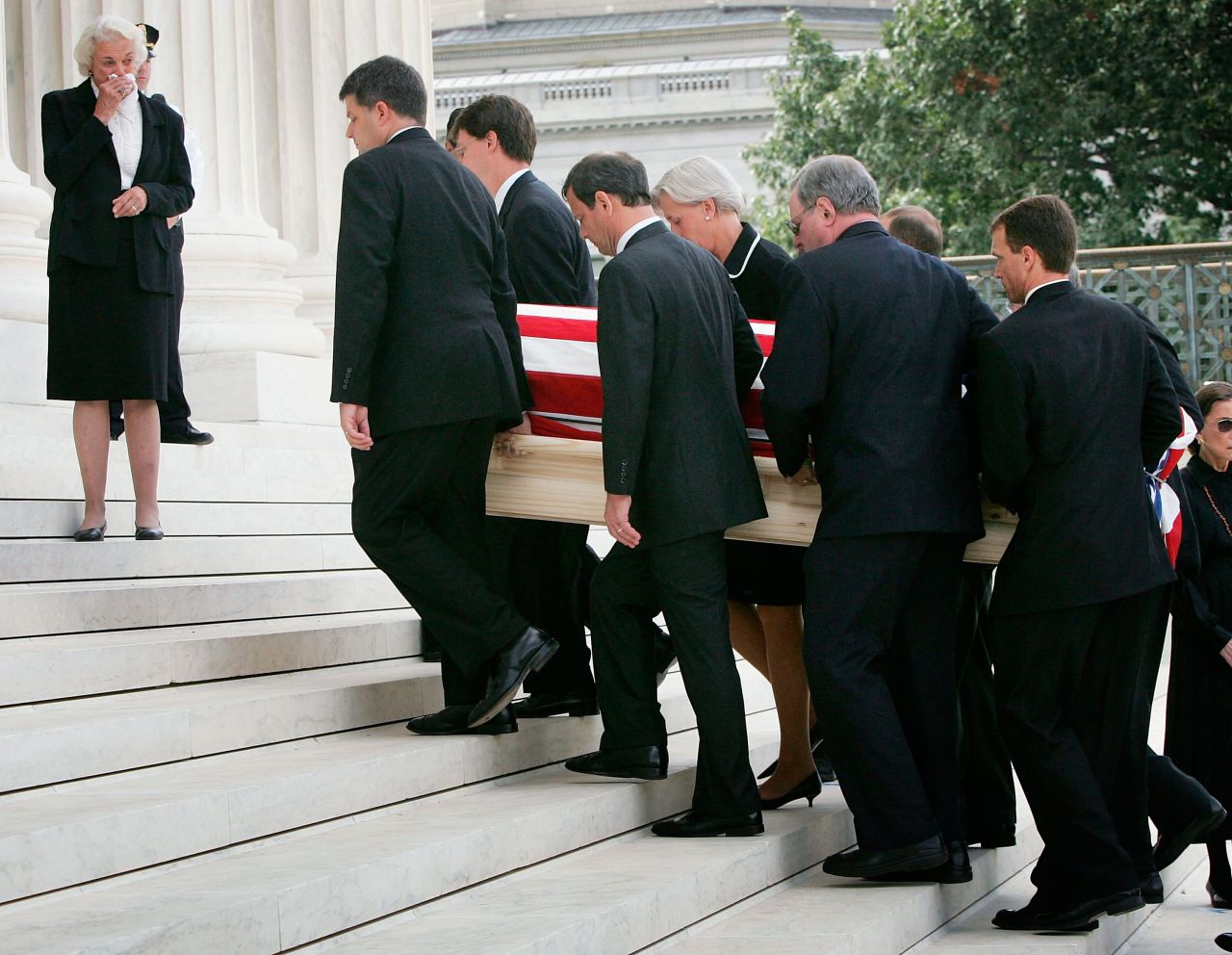 O'Connor weeps as Roberts and other pallbearers carry Rehnquist's casket into the Supreme Court. Roberts was once a law clerk for Rehnquist.