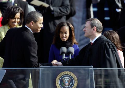 Roberts shakes hands with President Barack Obama at Obama's inauguration ceremony in 2009.