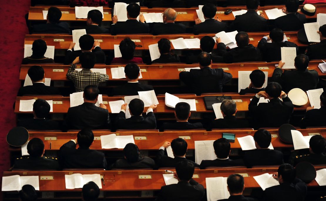 Delegates follow a speech at the Great Hall of the People in Beijing on March 9, 2010. Leaders have long sported impeccable jet-black hair. 