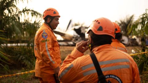 Members of the Colombian civil defense work where a plane crashed.
