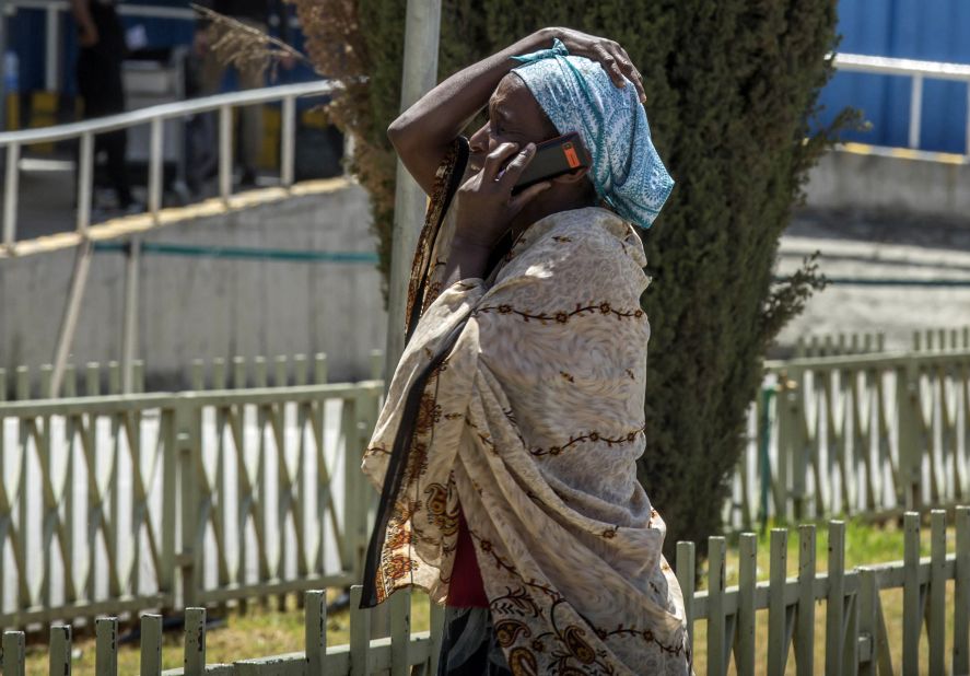 A victim's family member reacts as she speaks on a phone at the airport in Addis Ababa.