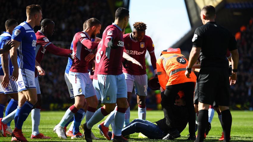 BIRMINGHAM, ENGLAND - MARCH 10: A pitch invader is hauled out a players huddle during the Sky Bet Championship match between Birmingham City and Aston Villa at St Andrew's Trillion Trophy Stadium on March 10, 2019 in Birmingham, England. (Photo by Alex Davidson/Getty Images)