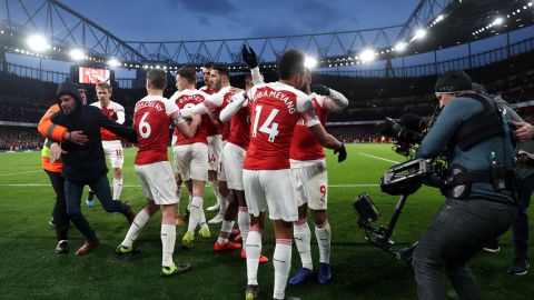 A fan (left) shoved Chris Smalling before celebrating with the Arsenal players.