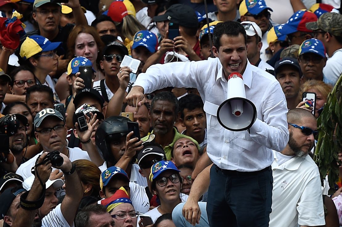 Guaido addresses supporters through a megaphone.