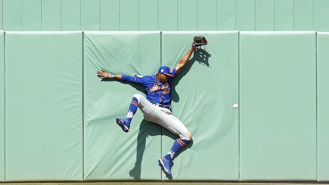Keon Broxton of the New York Mets crashes into the wall attempting to catch a fly ball during the sixth inning of a Grapefruit League spring training game against the Boston Red Sox on March 9, in Fort Myers, Florida.
