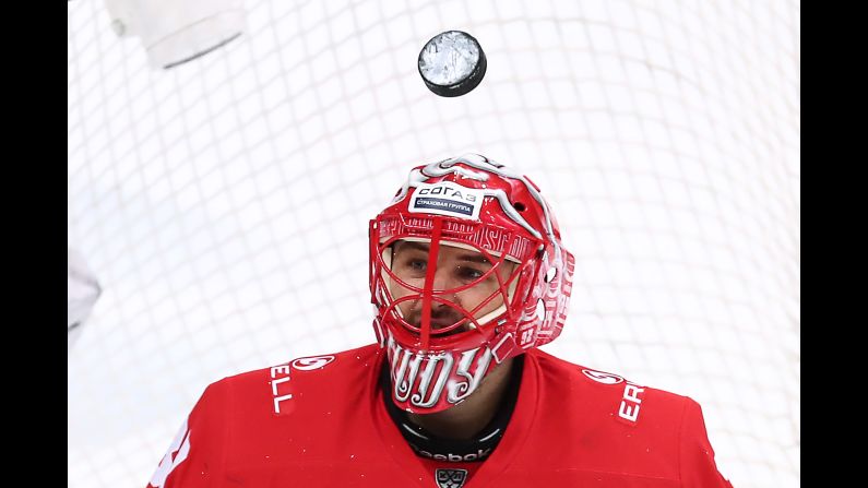 A puck soars over goalie Julius Hudacek of Spartak Moscow during the Western Conference quarterfinal game between Spartak Moscow and SKA Saint Petersburg in Moscow, Russia on Friday, March 8.