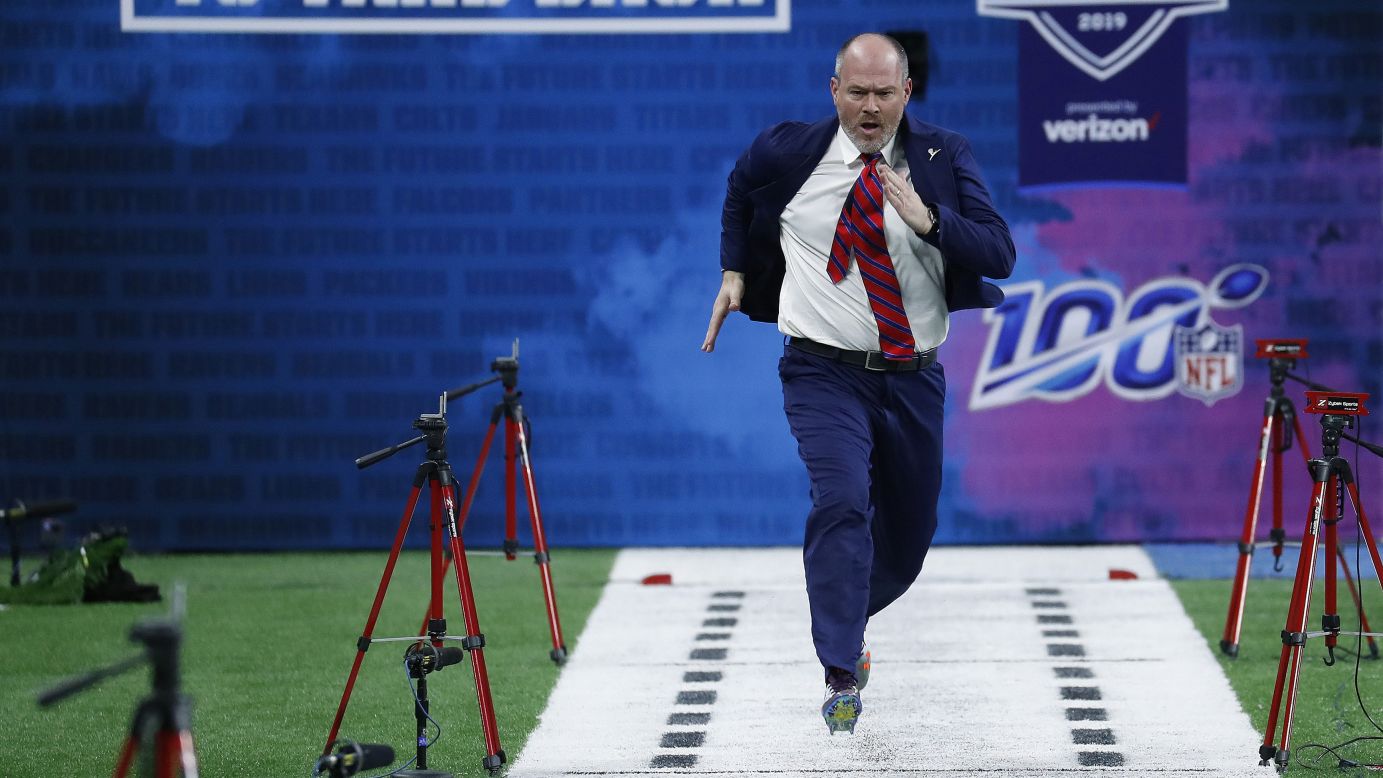 NFL Network announcer Rich Eisen runs the 40-yard dash during the NFL Combine at Lucas Oil Stadium on Sunday, March 3. Eisen, who has run in the combine for the past several years, has turned the humorous stunt into a way to raise money for St. Jude Children's Research Hospital.