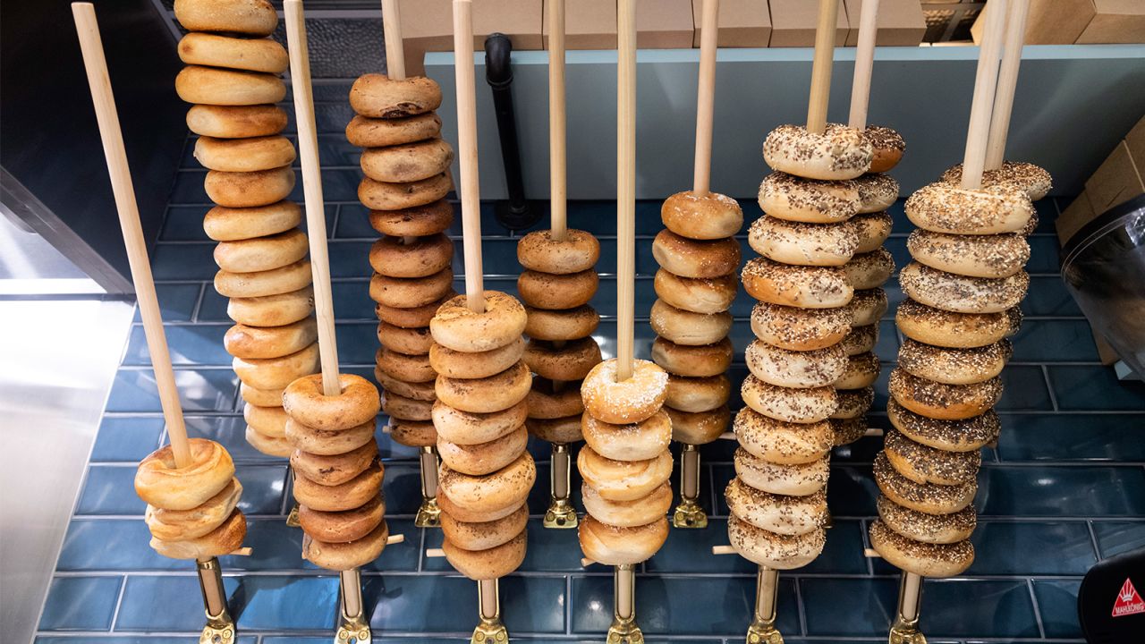Button & Co. bagels are stacked up on wooden poles so employees can quickly see what's available.