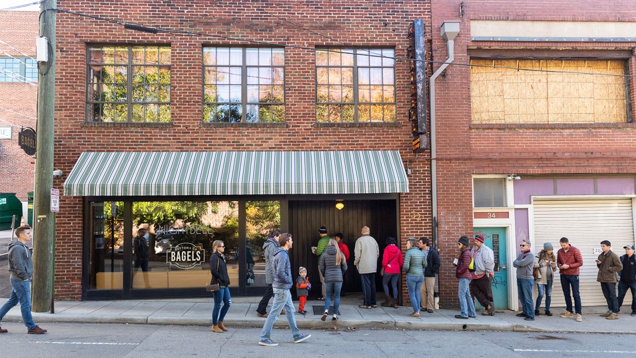 Asheville locals begin lining up outside of Button & Co. Bagels every morning.