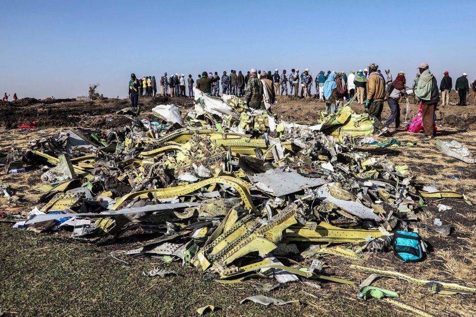 A crowd gathers near debris at the crash site of Ethiopian Airlines Flight ET302 on Monday, March 11.