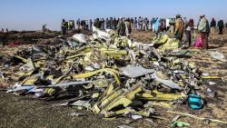 People stand near collected debris at the crash site of Ethiopia Airlines near Bishoftu, a town some 60 kilometres southeast of Addis Ababa, Ethiopia, on March 11, 2019. - An Ethiopian Airlines Boeing 737 crashed on March 10 morning en route from Addis Ababa to Nairobi with 149 passengers and eight crew believed to be on board, Ethiopian Airlines said. (Photo by Michael TEWELDE / AFP)        (Photo credit should read MICHAEL TEWELDE/AFP/Getty Images)