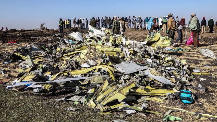 People stand near collected debris at the crash site of Ethiopia Airlines near Bishoftu, a town some 60 kilometres southeast of Addis Ababa, Ethiopia, on March 11, 2019. - An Ethiopian Airlines Boeing 737 crashed on March 10 morning en route from Addis Ababa to Nairobi with 149 passengers and eight crew believed to be on board, Ethiopian Airlines said. (Photo by Michael TEWELDE / AFP)        (Photo credit should read MICHAEL TEWELDE/AFP/Getty Images)