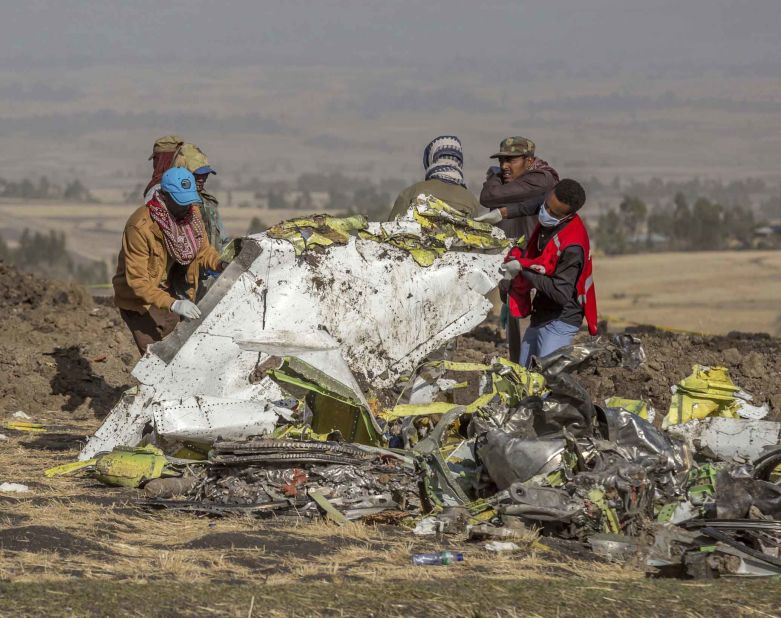 People work at the crash site on March 11.