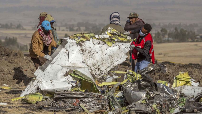 Rescuers work at the scene of an Ethiopian Airlines flight crash near Bishoftu, or Debre Zeit, south of Addis Ababa,  Ethiopia, Monday, March 11, 2019. A spokesman says Ethiopian Airlines has grounded all its Boeing 737 Max 8 aircraft as a safety precaution, following the crash of one of its planes in which 157 people were killed. (AP Photo/Mulugeta Ayene)