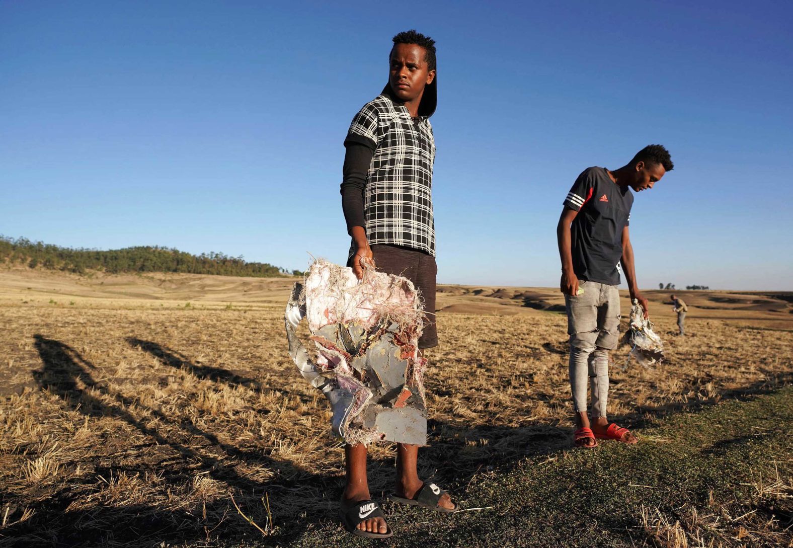 Residents of Bishoftu, Ethiopia, collect plane debris.