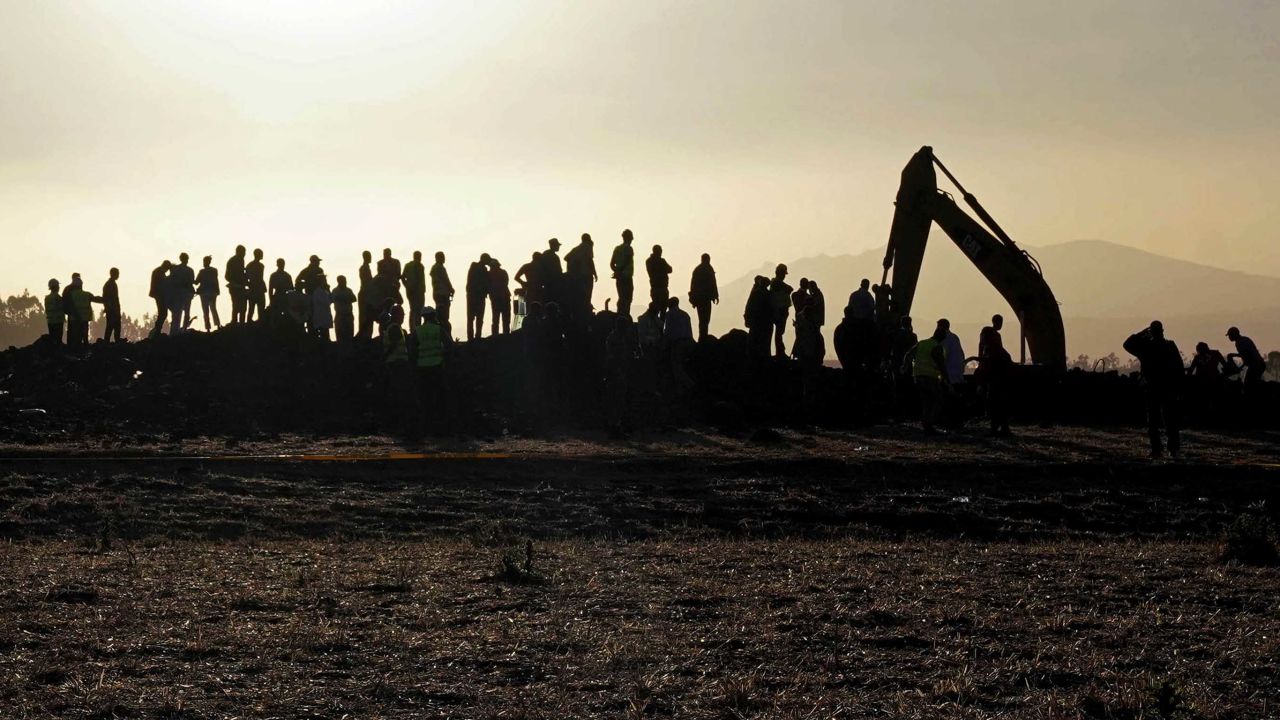 ADDIS ABABA, ETHIOPIA - MARCH 10: (EDITORS NOTE: Re-transmission of image 1134947788 with alternate crop) Rescue and recovery personnel use an earth mover to recover debris from a crater where Ethiopian Airlines Flight 302 crashed in a wheat field just outside the town of Bishoftu, 62 kilometers southeast of Addis Ababa on March 10, 2019 in Addis Ababa, Ethiopia. Flight 302 was just 6 minutes into its flight to Nairobi, Kenya, when it crashed killing all 157 passengers and crew on board. The cause of the crash has not yet been determined. (Photo by Jemal Countess/Getty Images)