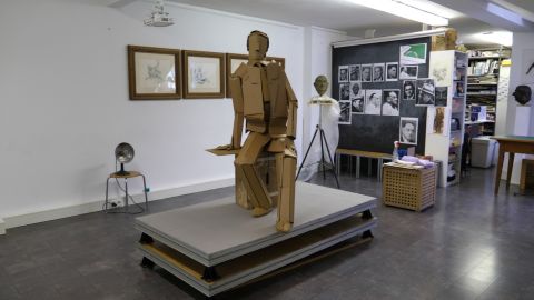 A cardboard version of the statue stands in the studio.