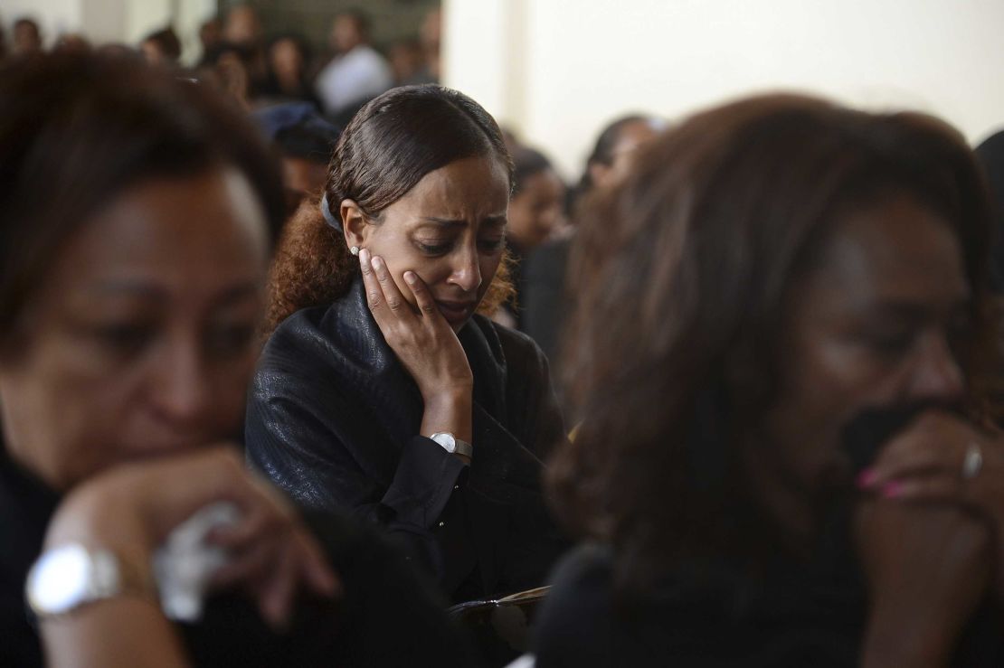 Mourners attend a memorial service for crew members who died in the crash.