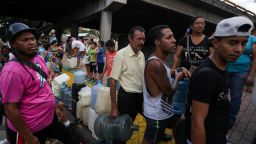 People queue to collect potable water in Caracas on March 10, 2019, during the third day of a massive power outage which has left Venezuelans without communications, electricity and water. - The unprecedented power outage already left 15 patients dead and threatens to extend indefinitely, increasing distress for the severe political and economic crisis hitting the oil-rich South American nation. (Photo by Cristian Hernandez / AFP)        (Photo credit should read CRISTIAN HERNANDEZ/AFP/Getty Images)
