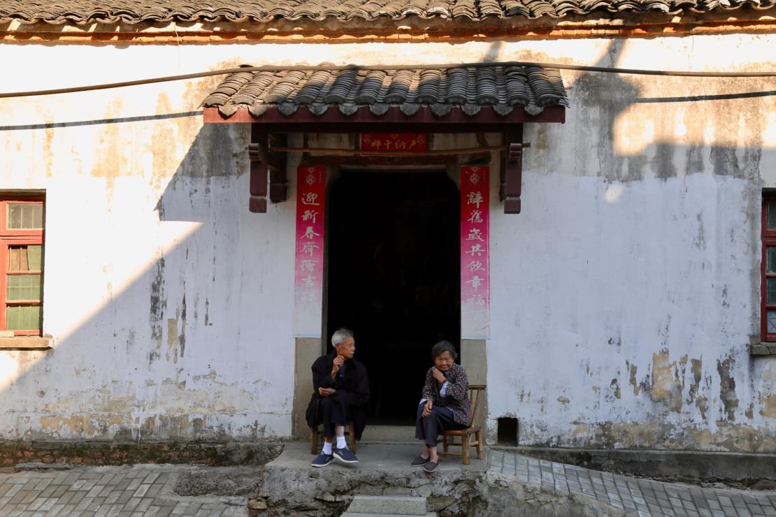 Two villagers sit in front of a local cottage in Sanbao village where a group of international artists settle in and turn farmhouses into ceramic studios. 