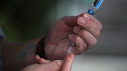 LOS GATOS, CA - JANUARY 25:  Veterinarian technician Justin Jones prepares a syringe with a canine influenza vaccine at Los Gatos Dog and Cat Hospital on January 25, 2018 in Los Gatos, California. Veternarians have seen a surge in dog owners seeking to have their dogs immunized for "dog flu" after reports that the highly contagious canine influenzaÑH3N2 and H3N8Ñis rapidly spreading.  (Photo by Justin Sullivan/Getty Images)