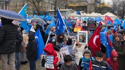 Demonstrators wave Uyghur nationalist flags in central Istanbul as they hold up photos of missing relatives caught up in China's crackdown on the Uyghur minority group.