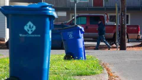 Blue recycling bins are seen on a residential street in Portland, Oregon. Coca-Cola will use learnings from its Atlanta program to help scale its recycling efforts. 