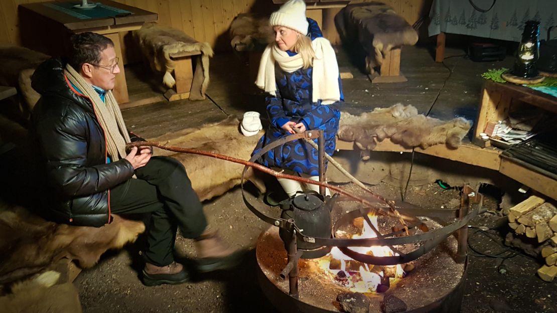 Cooking traditional makkara sausages inside a kota tent.