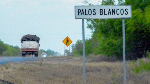A truck drives past a sign on the Reynosa-San Fernando highway, near the location where 19 migrants went missing.