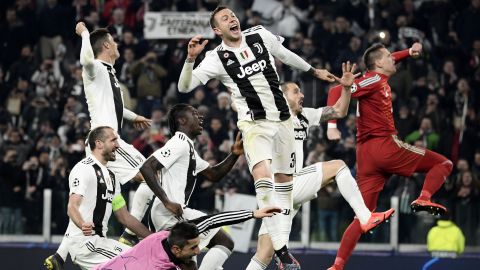 Juventus players celebrate after defeating Atletico Madrid in Turin.