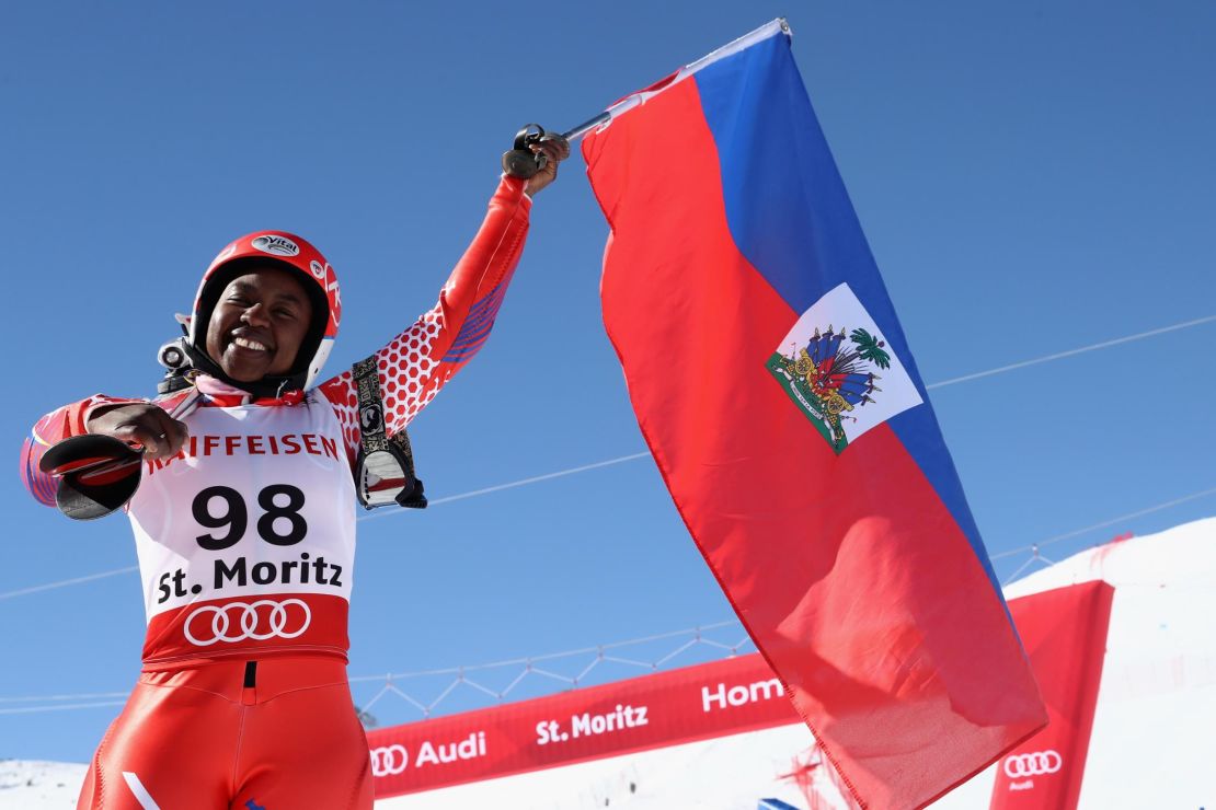 Marti waves her national flag at the finish area in St Moritz.